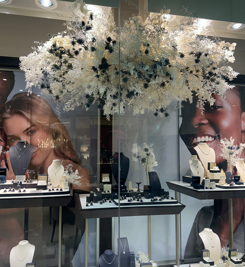 Luxury brand activation floral installation suspended above jewellery retail display by Muse Styling Scotland