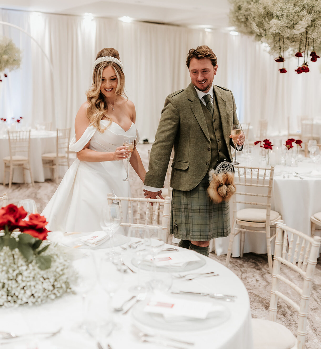 Bride and groom entering wedding reception with table styling and florals at Cameron House by Muse Styling