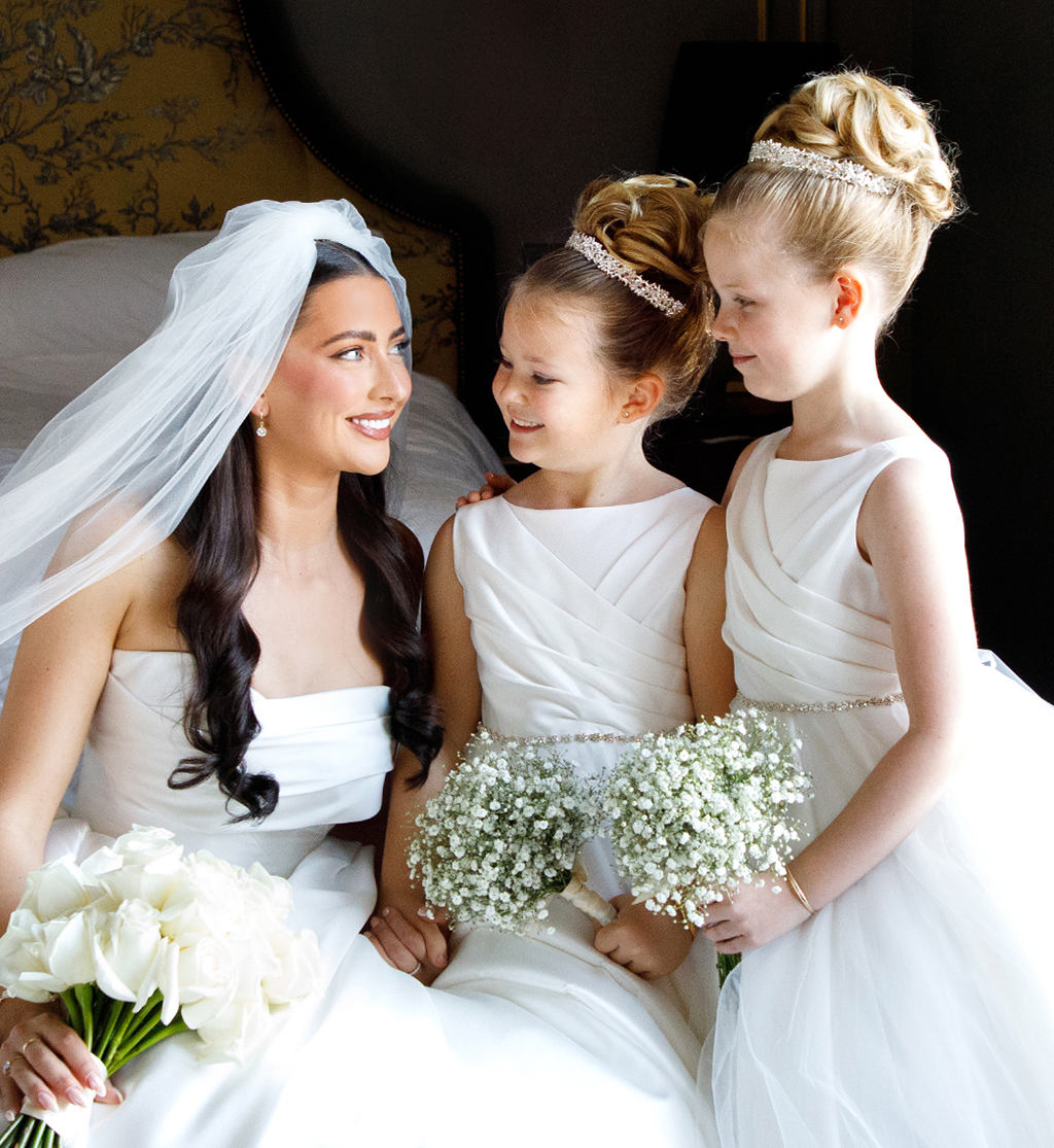 Bride with flower girls holding white flowers during wedding morning at Cameron House by Muse Styling