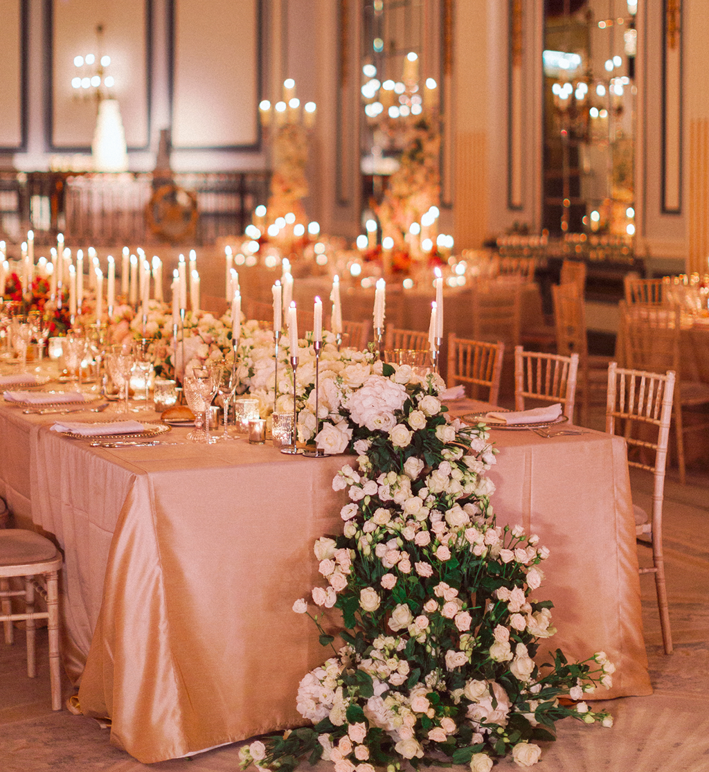 Top table with cascading floral arrangement and candlelight at Gleneagles wedding by Muse Styling