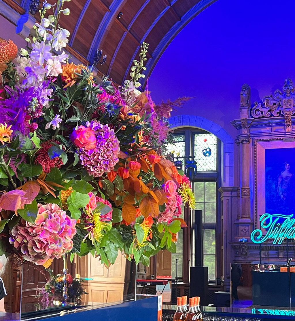 Colourful statement floral arrangement with vibrant seasonal flowers styled for a luxury event gala ball by Muse Styling Scotland