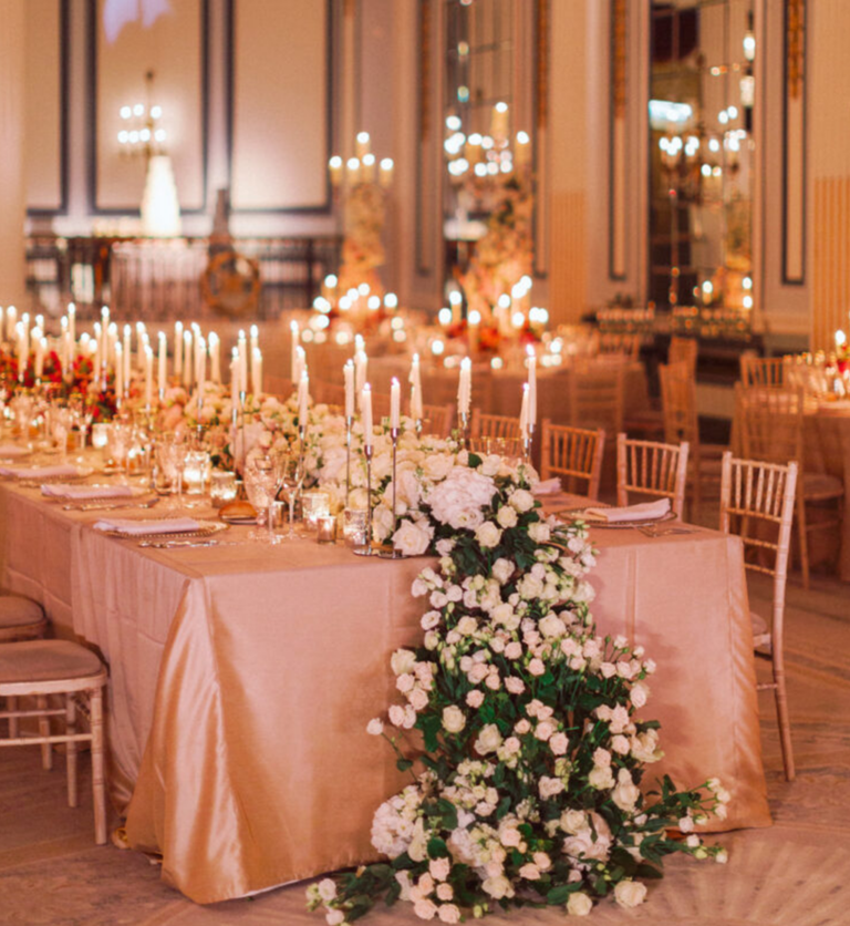 Top table with cascading floral arrangement and candlelight at Gleneagles wedding by Muse Styling