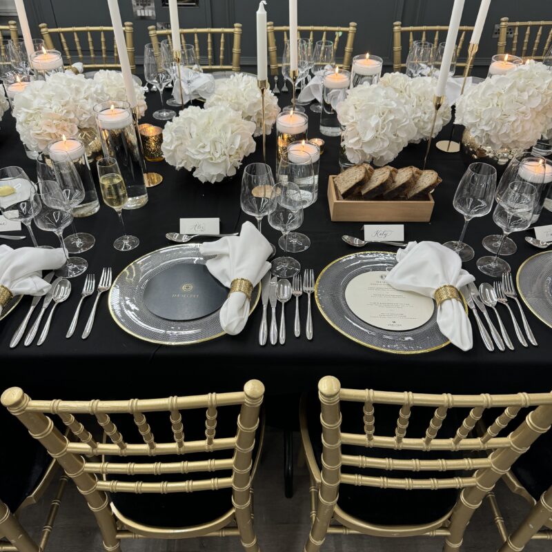 Luxury black and gold event table styling with candlelight, hydrangea centrepieces and elegant place settings by Muse Styling Scotland