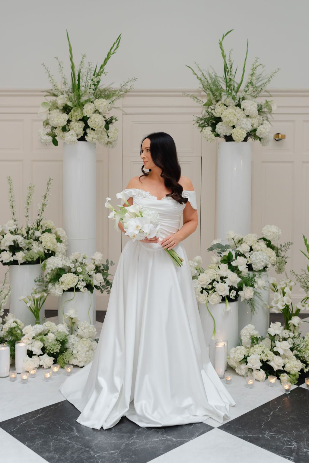 Bride standing beside elegant white ceremony floral arrangements with roses and hydrangea, design-led wedding styling by Muse Styling Collectors Hall Wedding Glasgow