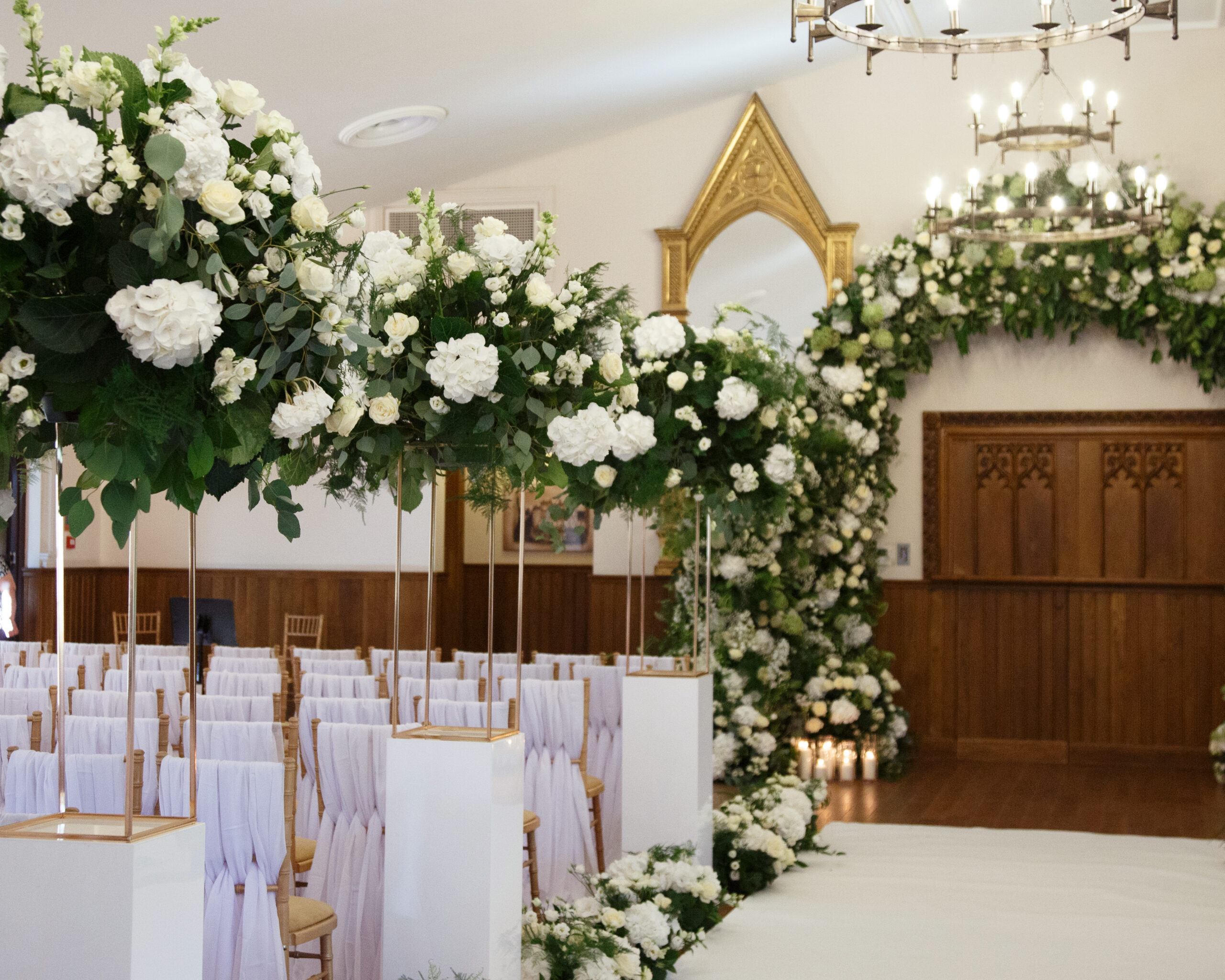 Elegant wedding aisle flowers in white and green at Crossbasket Castle with luxury styling by Muse Styling