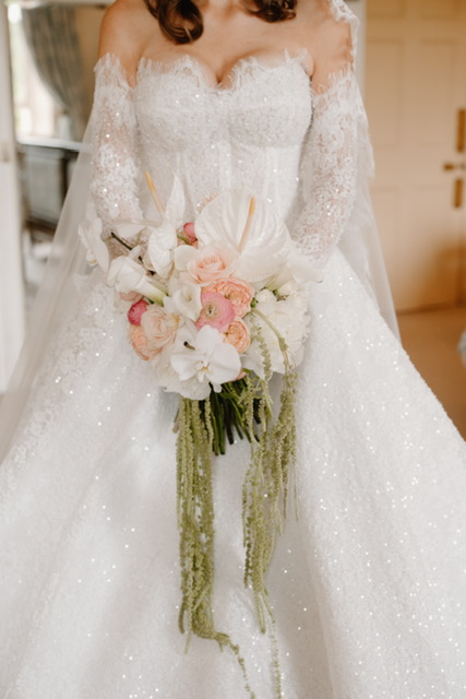 Bride holding bespoke orchid and peony wedding bouquet during a luxury Scottish castle wedding at Dundas Castle.