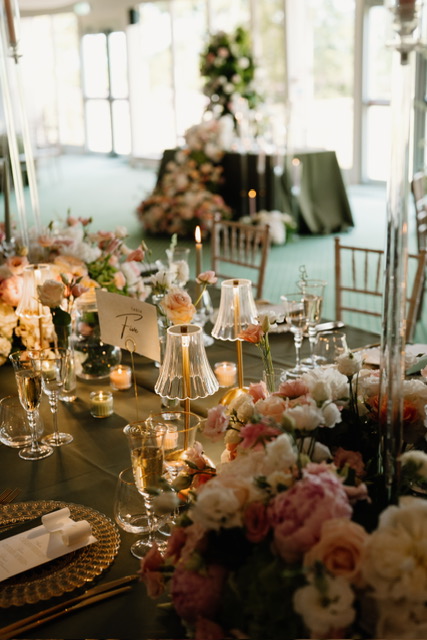 Elegant wedding reception at Dundas Castle featuring tall floral centrepieces and luxury table styling.